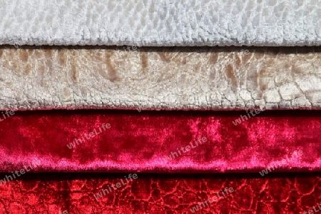 Detailed close up view on samples of cloth and fabrics in different colors found at a fabrics market.