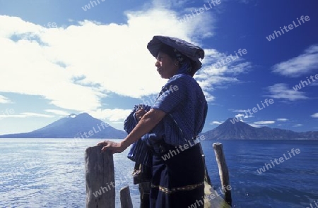 People at the coast of Lake Atitlan mit the Volcanos of Toliman and San Pedro in the back at the Town of Panajachel in Guatemala in central America.   