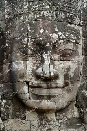 Stone Faces the Tempel Ruin of Angkor Thom in the Temple City of Angkor near the City of Siem Riep in the west of Cambodia.