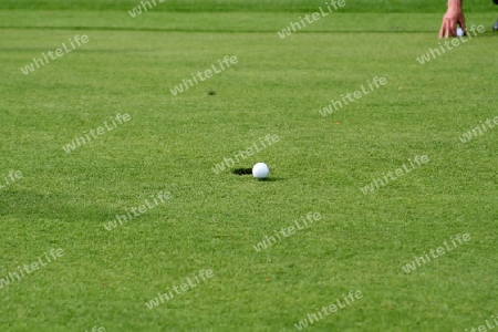 Golfball vor dem Loch