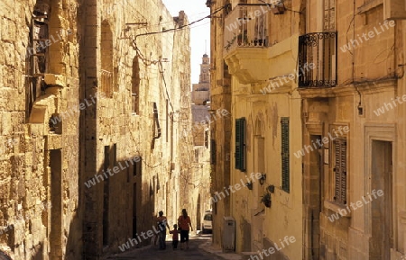 A smal road in the centre of the Old Town of the city of Valletta on the Island of Malta in the Mediterranean Sea in Europe.
