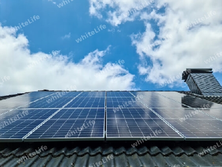 Solar panels producing clean energy on a roof of a residential house