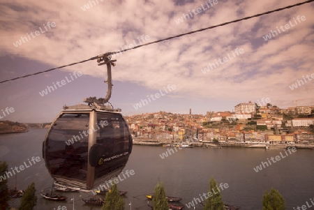 the cablecar and the old town on the Douro River in Ribeira in the city centre of Porto in Porugal in Europe.