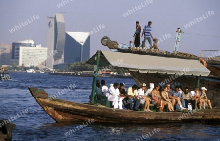 a city boat and ferry on the Dubai creek in the old town in the city of Dubai in the Arab Emirates in the Gulf of Arabia.