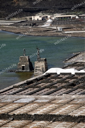 The Salinas in the Laguna of El Charco on the Island of Lanzarote on the Canary Islands of Spain in the Atlantic Ocean.