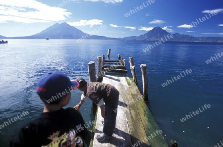 The Lake Atitlan mit the Volcanos of Toliman and San Pedro in the back at the Town of Panajachel in Guatemala in central America.   