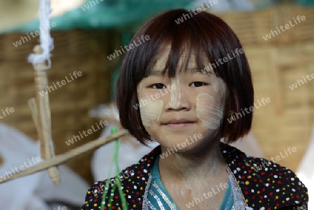 a girl at the Market at the Village of Phaung Daw Oo at the Inle Lake in the Shan State in the east of Myanmar in Southeastasia.