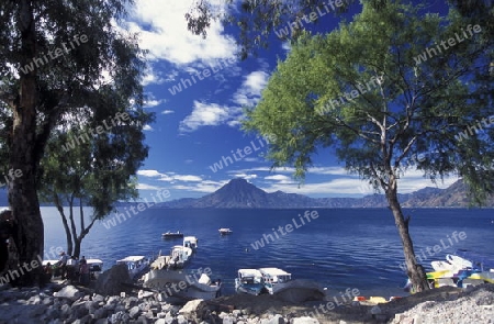 The Lake Atitlan mit the Volcanos of Toliman and San Pedro in the back at the Town of Panajachel in Guatemala in central America.   