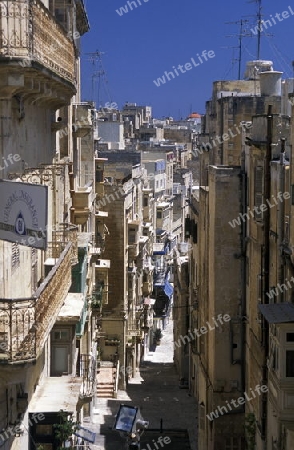 A smal road in the centre of the Old Town of the city of Valletta on the Island of Malta in the Mediterranean Sea in Europe.
