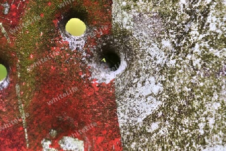 Detailed close up of bullet holes from gun shots in a german traffic sign