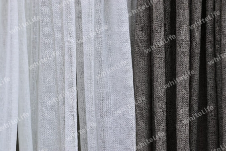 Detailed close up view on samples of cloth and fabrics in different colors found at a fabrics market.