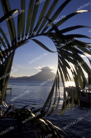 The Lake Atitlan mit the Volcanos of Toliman and San Pedro in the back at the Town of Panajachel in Guatemala in central America.   