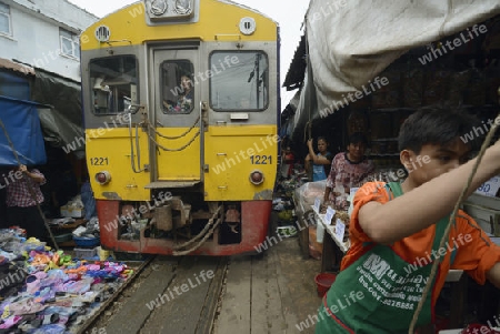 the Maeklong Railway Markt at the Maeklong railway station  near the city of Bangkok in Thailand in Suedostasien.