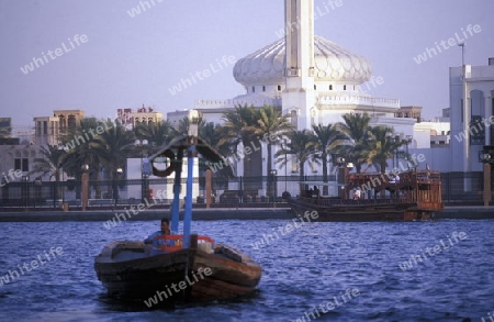 a city boat and ferry on the Dubai creek in the old town in the city of Dubai in the Arab Emirates in the Gulf of Arabia.