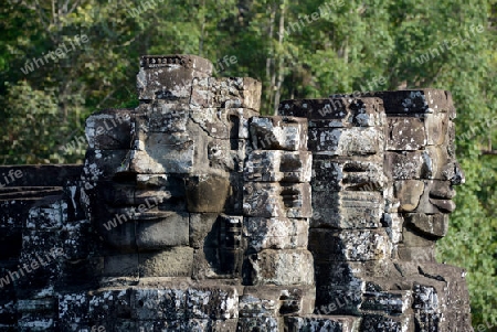 Stone Faces the Tempel Ruin of Angkor Thom in the Temple City of Angkor near the City of Siem Riep in the west of Cambodia.