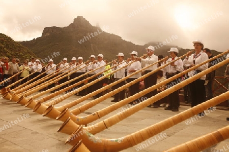 Swiss Alphorn player in the  mountain Village of  Tejeda in the centre of the Canary Island of Spain in the Atlantic ocean.