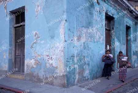  indio women in the old town in the city of Antigua in Guatemala in central America.   