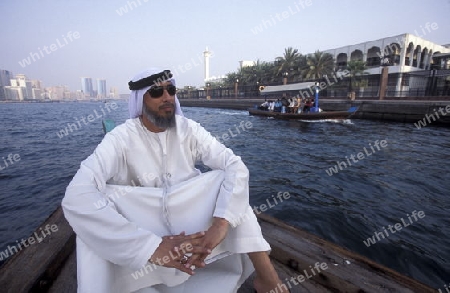 a city boat and ferry on the Dubai creek in the old town in the city of Dubai in the Arab Emirates in the Gulf of Arabia.