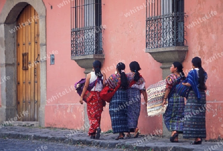  indio women in the old town in the city of Antigua in Guatemala in central America.   