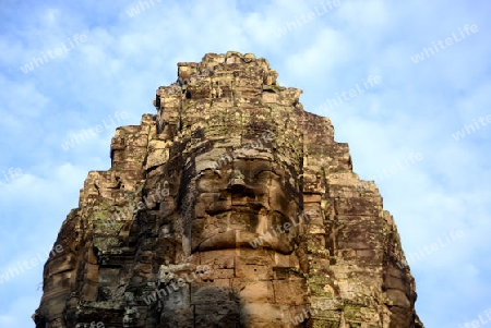 Stone Faces the Tempel Ruin of Angkor Thom in the Temple City of Angkor near the City of Siem Riep in the west of Cambodia.