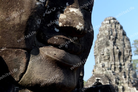 Stone Faces the Tempel Ruin of Angkor Thom in the Temple City of Angkor near the City of Siem Riep in the west of Cambodia.