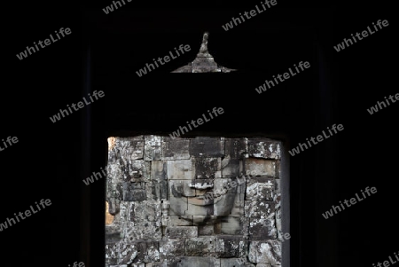 Stone Faces the Tempel Ruin of Angkor Thom in the Temple City of Angkor near the City of Siem Riep in the west of Cambodia.