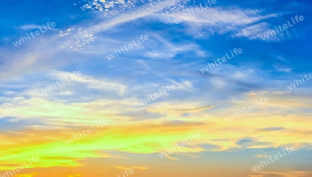 Beautiful high resolution panorama of orange and red sunset clouds in the evening sky.