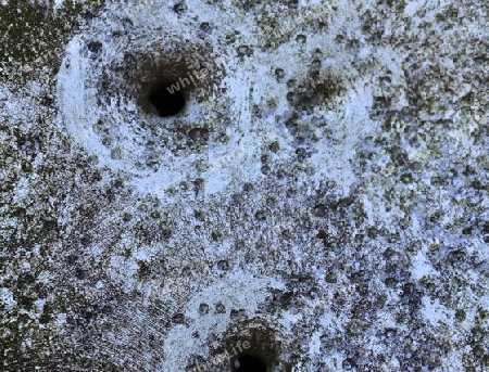 Detailed close up of bullet holes from gun shots in a german traffic sign