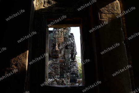 Stone Faces the Tempel Ruin of Angkor Thom in the Temple City of Angkor near the City of Siem Riep in the west of Cambodia.