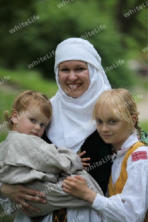 a Women in traditional dress on a Summer Festival in a Parc in the old City of Vilnius in the Baltic State of Lithuania,  