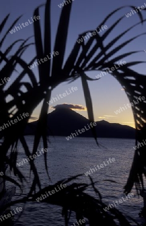 The Lake Atitlan mit the Volcanos of Toliman and San Pedro in the back at the Town of Panajachel in Guatemala in central America.   