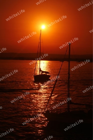 a Sunset at the old Town of Siracusa in Sicily in south Italy in Europe.