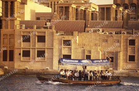 a city boat and ferry on the Dubai creek in the old town in the city of Dubai in the Arab Emirates in the Gulf of Arabia.