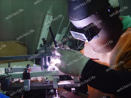 Welder weding in a factory