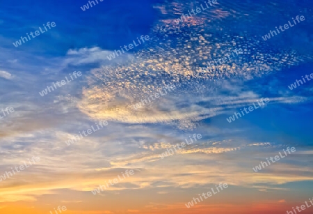 Beautiful high resolution panorama of orange and red sunset clouds in the evening sky.