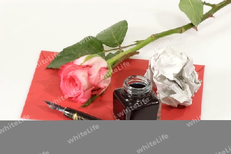 Rose mit Papier und Schreibutensilien