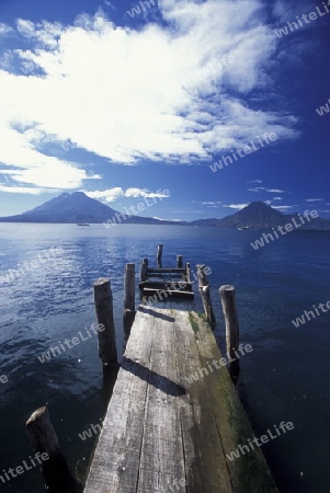 The Lake Atitlan mit the Volcanos of Toliman and San Pedro in the back at the Town of Panajachel in Guatemala in central America.   