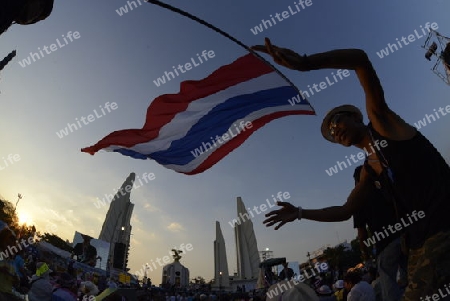 Thai anti-government protesters wave national flags during a rally at theDemocracy Monument in .Bangkok, Thailand, Saturday Jan.11 , 2014.