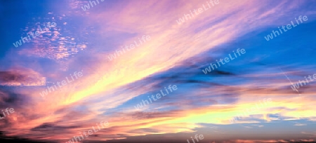 Beautiful high resolution panorama of orange and red sunset clouds in the evening sky.