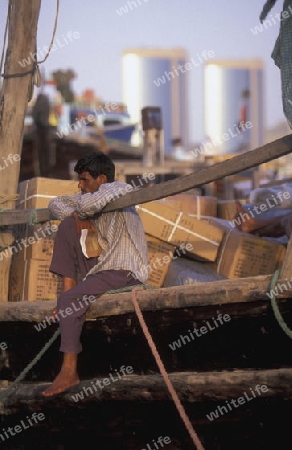 Import and export goods at the harbour at the Dubai creek in the old town in the city of Dubai in the Arab Emirates in the Gulf of Arabia.