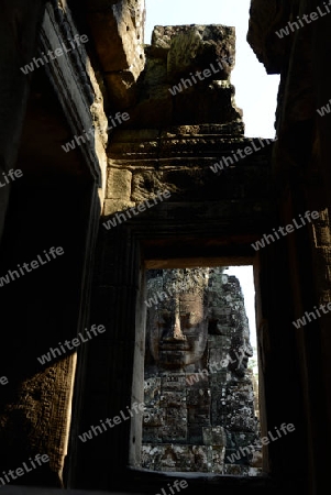 Stone Faces the Tempel Ruin of Angkor Thom in the Temple City of Angkor near the City of Siem Riep in the west of Cambodia.