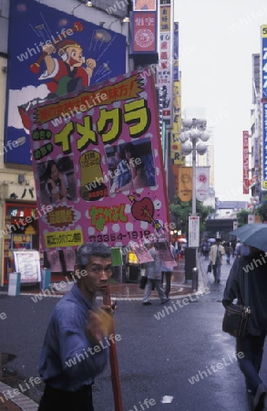 a streetworker in the city centre of Tokyo in Japan in Asia,



