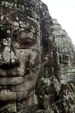 Stone Faces the Tempel Ruin of Angkor Thom in the Temple City of Angkor near the City of Siem Riep in the west of Cambodia.