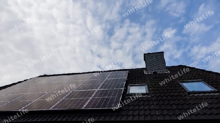 Solar panels producing clean energy on a roof of a residential house