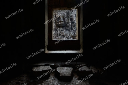 Stone Faces the Tempel Ruin of Angkor Thom in the Temple City of Angkor near the City of Siem Riep in the west of Cambodia.