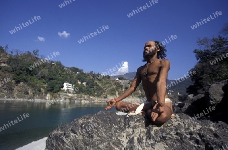 a men on the Ganges River in the town of Rishikesh in the Province Uttar Pradesh in India.