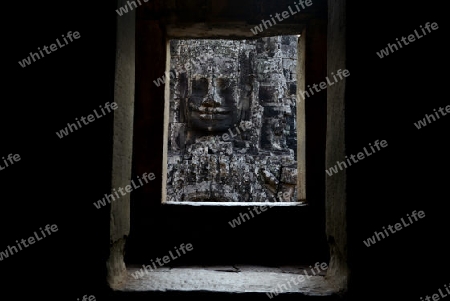 Stone Faces the Tempel Ruin of Angkor Thom in the Temple City of Angkor near the City of Siem Riep in the west of Cambodia.