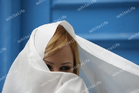 Afrika, Nordafrika, Tunesien, Tunis, Sidi Bou Said
Junge Frauen im traditionellen weissen Schleier in der Altstadt von Sidi Bou Said in der Daemmerung am Mittelmeer und noerdlich der Tunesischen Hauptstadt Tunis. 





