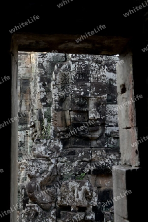 Stone Faces the Tempel Ruin of Angkor Thom in the Temple City of Angkor near the City of Siem Riep in the west of Cambodia.