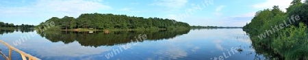 Beautiful high resolution panorama of a northern european country landscape with fields and green grass.